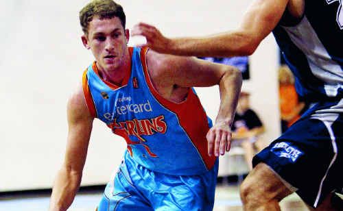 Cairns Marlins’ James Comino looks to drive past Rockhampton’s Stephen Weigh. Cairns Marlins’ James Comino looks to drive past Rockhampton’s Stephen Weigh.